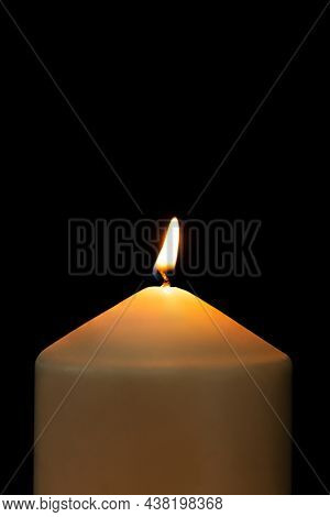 Burning candle light realistic flame, black background high resolution image