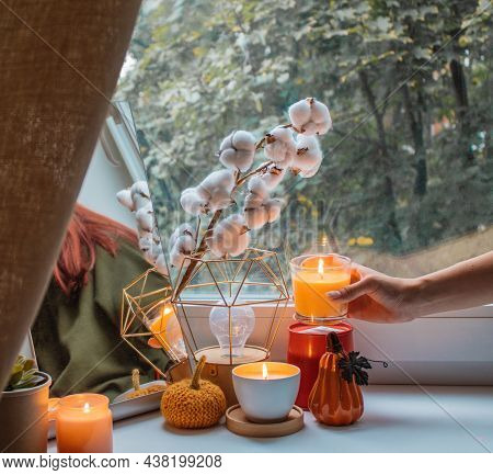 Girl Decorates The Window Sill In Her Room For The Holiday. She Made A Composition Of Mirror, Flower