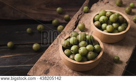 Wild Indian Gooseberry Or Amla In A Bowl On Wooden Background, Fruit Tree In Asia Use In Various Cui
