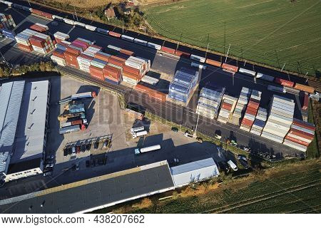 Containers Warehouse On Platform With Cranes And Forklifts, Aerial View. Business And Logistic Conce