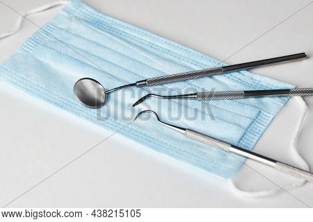 Dentist Tools And Medical Mask On White Background