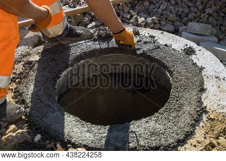 A Worker The New Road Construction Work On Preparation For Installation Of Sewer Manholes Hatches