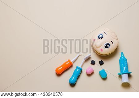 Childrens Set Of Dentist With Tools And Play Doll Head Mockup. Tablet For Recording. Copy Space Flat