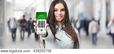Green Pass Covid-19 Vaccination Certificate Concept, Smiling Woman Show Digital Vaccine Certificatio