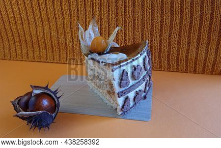 Piece Of Fruit Cake, Fruits Of Prickly Chestnut On Orange Background