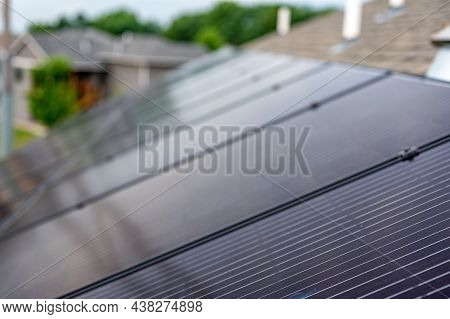 Selective Focus On Solar Panels Installed On A Residential Asphalt Shingle Roof