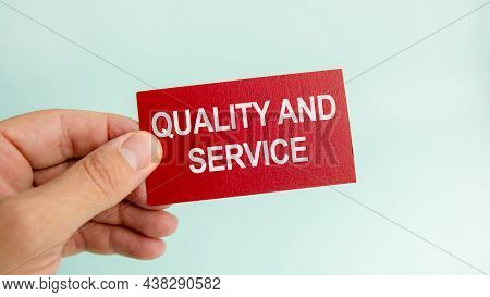Message On The Card With Text Quality And Service, In Hand Of Businessman.
