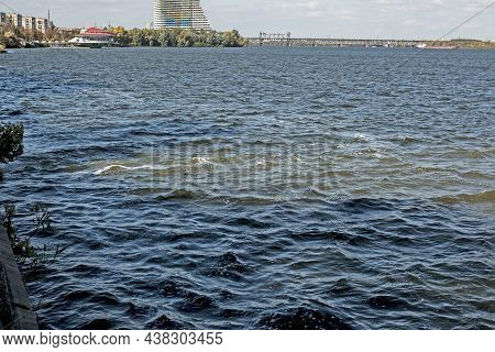 Dirty Orange Water From Sewage Pipeline Mixes With River Water.
