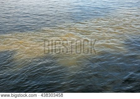 Dirty Orange Water From Sewage Pipeline Mixes With River Water.