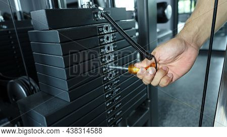 Male Hand Select Weight. Hands On Pin Piles Of Metal Weights Or Exercise Machines For Bodybuilders I