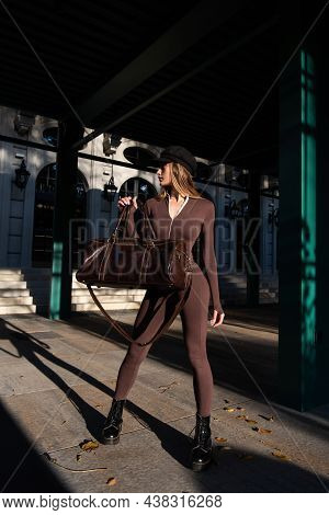 Fashionable Young Brunette Woman With Long Legs Wearing Solid Long Sleeve Bodycon One Piece Jumpsuit