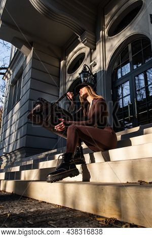 Fashionable Young Brunette Woman With Long Legs Wearing Solid Long Sleeve Bodycon One Piece Jumpsuit