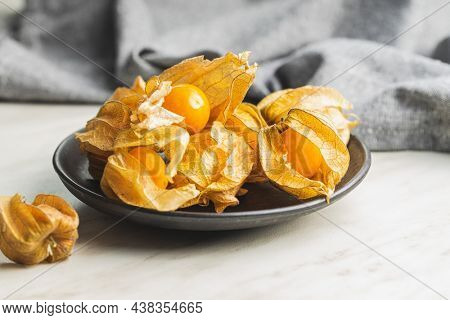 Physalis peruviana. Cape Gooseberry or ground cherries fruit on kitchen table.