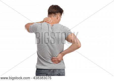 Tired Young Caucasian Male Massaging Sore Spots And Suffering From Back And Neck Pain
