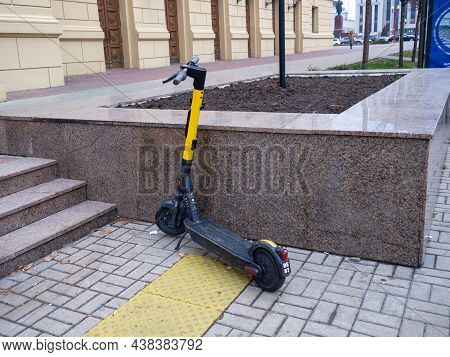 Electric Scooter Left On The Sidelines. Scooter On The Street.