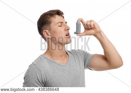 Calm Concentrated Millennial Caucasian Attractive Male Suffering From Asthma And Spraying Inhaler In