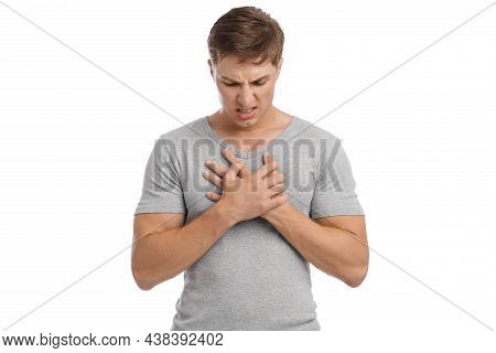 Sad Despaired Millennial Caucasian Handsome Guy Presses Hands To Sore Spot And Suffers From Chest Pa