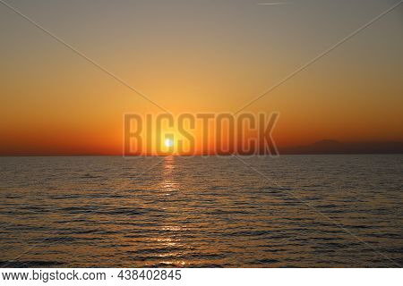 Orange-yellow Sea Sunset On The Dark Sea Surface