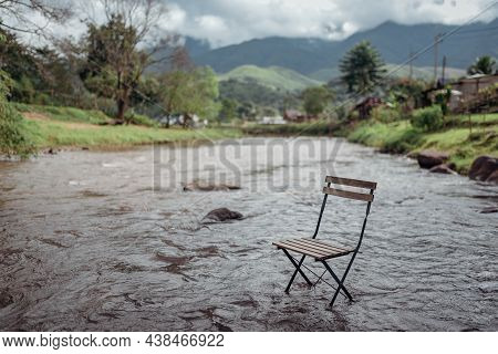 Beautiful Landscape Scenic Of The Wooden Chair In The River With The Fog And Mountain Background At 