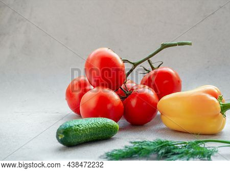 Tomato Branch, Cucumber And Yellow Pepper On Bright Background