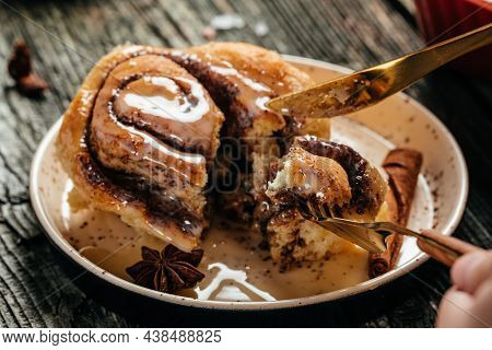 Cinnamon Rolls Or Cinnabon On A Plate On A Wooden Table. Food Recipe Background. Close Up.