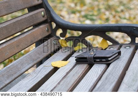 Lost Phone On The Bench. Concept Of No Wire, Being Disconnected. Forgotten Or Lost By Someone Smartp