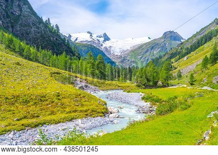 Idyllic Alpine Landscape With Grossvenediger Mountain. Small Mountain Creek In Gschloess Valley. Hoh