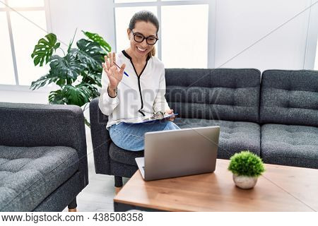Young hispanic woman having teleconsultation psychology session at psychology clinic