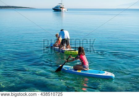 Happy Family On Sup Stand Up Paddle On Vacation.