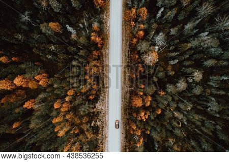 Aerial View Of Rural Road With Red Car In  Autumn Forest.