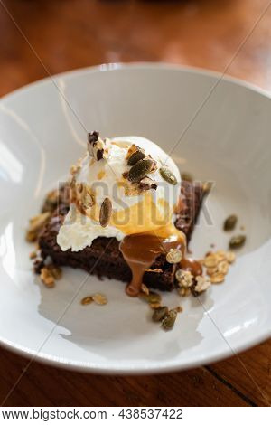 Demonstration Of The Finished Dish. Technology For Making Desserts At Home. Serving Brownie In A Pla