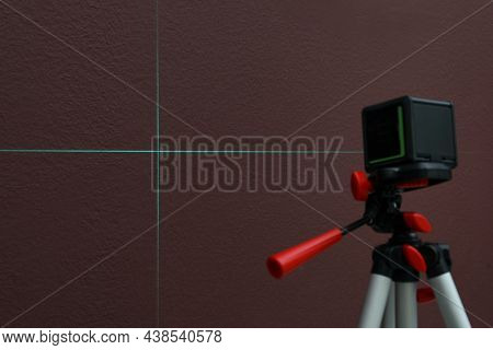 Cross Lines Of Laser Level On Brown Wall