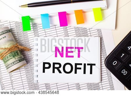 On A Light Background, A Pen, Dollars, A Notebook With The Text Nen Profit And Bright Stickers. Busi
