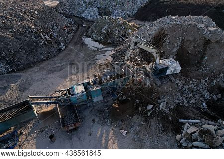 Excavator At Landfill The Load Concrete Waste In A Mobile Jaw Crusher Machine. Disposal Of Construct