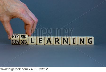 Blended Or Hybrid Learning Symbol. Businessman Turns Cubes, Changes Words Blended Learning To Hybrid