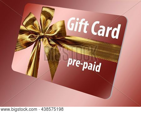 A Pre-paid Gift Card Is Seen Here. It Is Gold With A Gold Ribbon Design On The Front.this Is A 3-d I