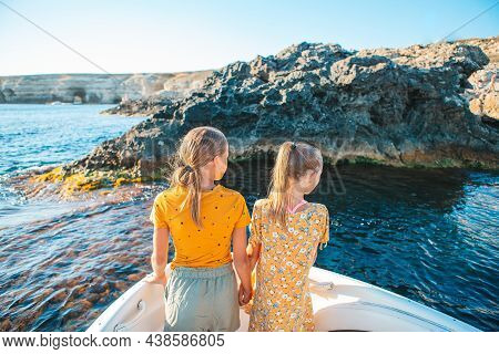Little Girls Sailing On Boat In Clear Open Sea