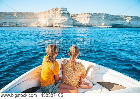Little Girls Sailing On Boat In Clear Open Sea