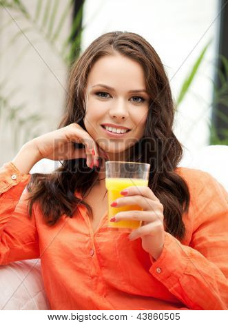 jeune femme tenant le verre de jus d'orange