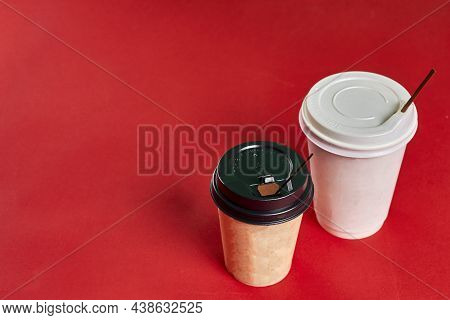 Two Single-use Plastic Coffee Cups On Red Background With Copy Space