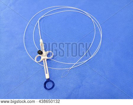 Closeup Image Of Endoscopic Instrument Polypectomy Snare In Blue Background. Selective Focus