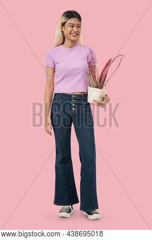 Asian woman holding potted plant
