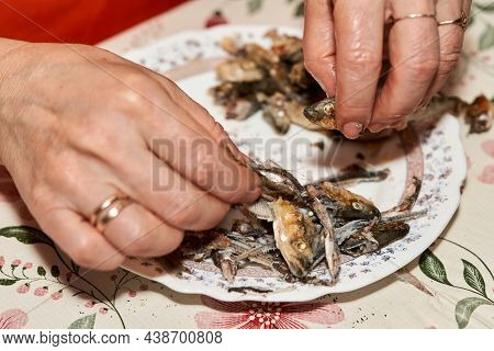 Hands Cut Fried Fish Smelt Separating The Flesh From The Bones