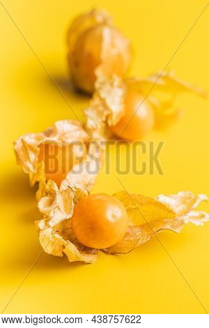 Physalis peruviana. Cape Gooseberry or ground cherries fruit on yellow background.