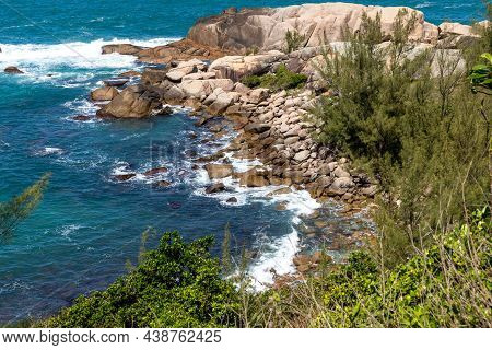 Cliff Rocks With Vegetation And Waves
