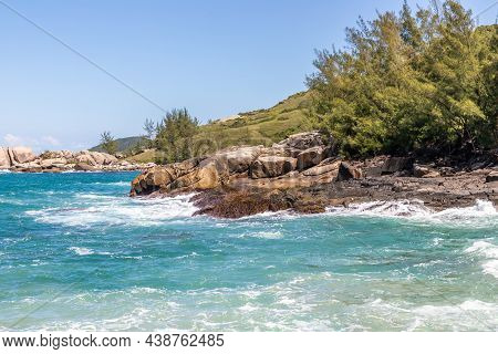 Cliff Rocks With Vegetation And Waves