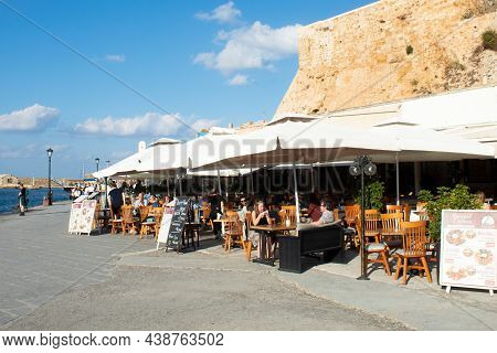 Chania, Crete - Greece - October 20 2021 :  Charming Pavement Taverna At The Historic Venetian Harbo