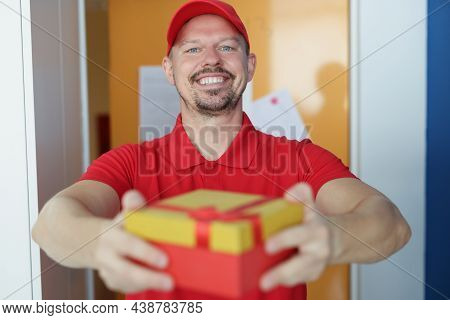Portrait Of Smiling Courier Delivering Package To Owner, Fast Delivery Service, Gift Box With Red Bo