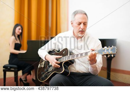 Guitarist playing an archtop guitar
