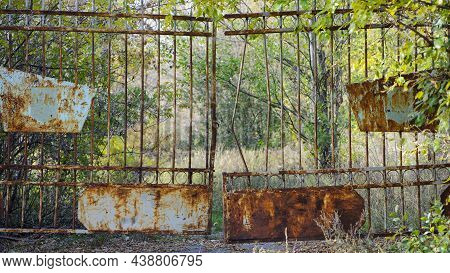 Old Rusty Iron Gate With A Deadbolt. Old Rusty Iron. Rusty Grungy Old Metal Texture For Use As A Bac